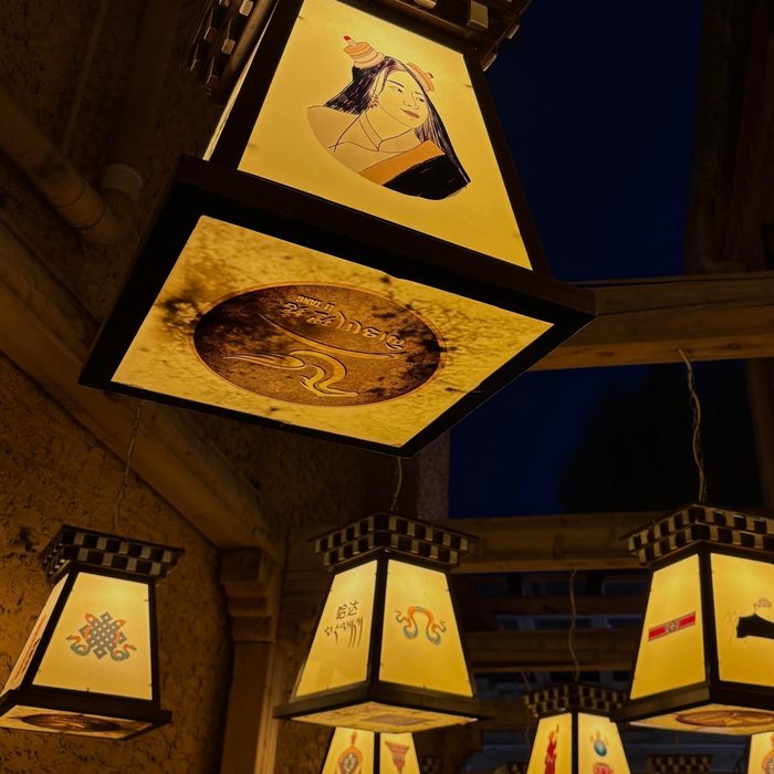 Hanging paper lanterns lit up at dusk